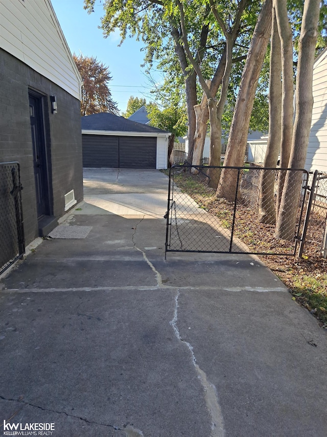 view of patio with an outbuilding and a garage