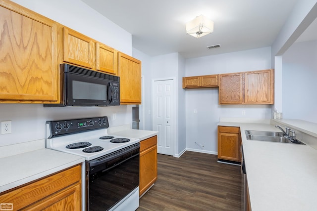 kitchen featuring white range with electric stovetop, dark hardwood / wood-style floors, and sink