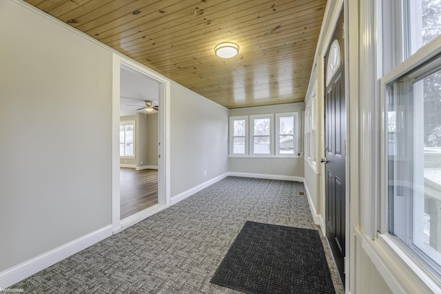 unfurnished sunroom with ceiling fan and wooden ceiling