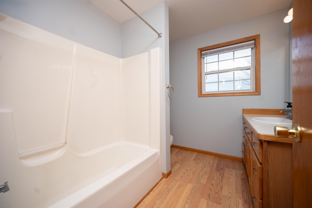 full bathroom featuring shower / tub combination, vanity, wood-type flooring, and toilet