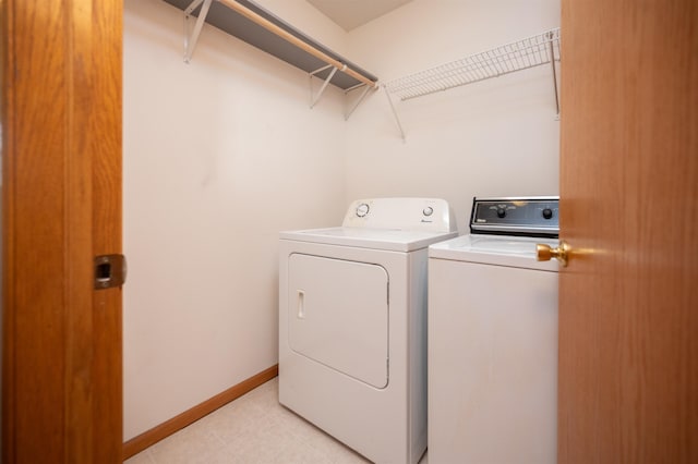 clothes washing area with washer and clothes dryer