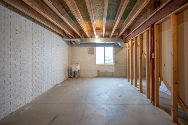 basement with sink and brick wall