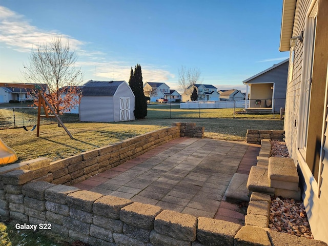 view of patio / terrace featuring a storage unit and a playground