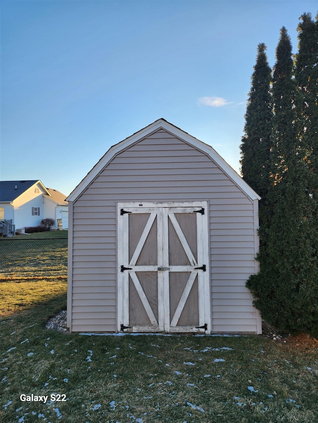 view of outbuilding with a yard