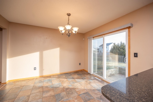 unfurnished dining area with an inviting chandelier