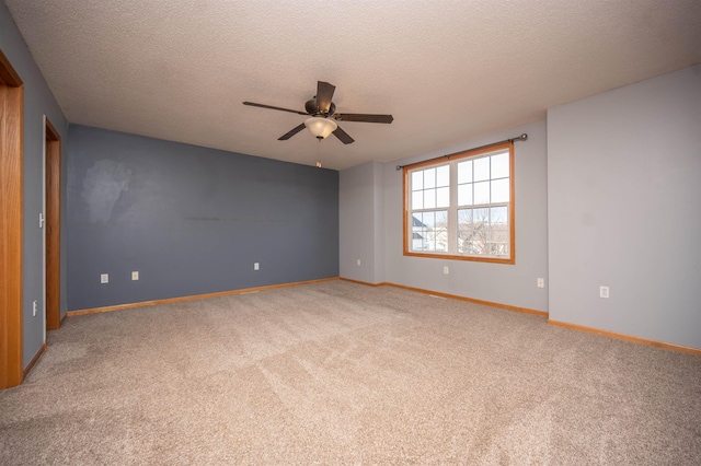 empty room with ceiling fan, carpet floors, and a textured ceiling