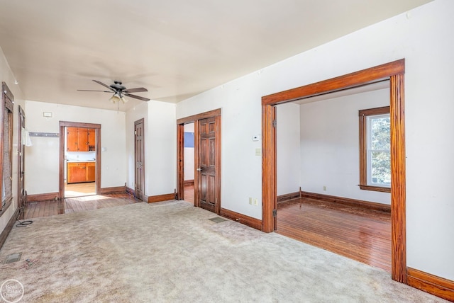 unfurnished bedroom featuring ceiling fan and light colored carpet