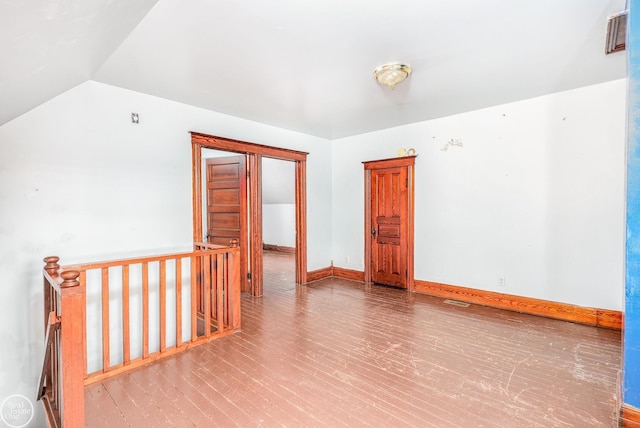 spare room featuring lofted ceiling