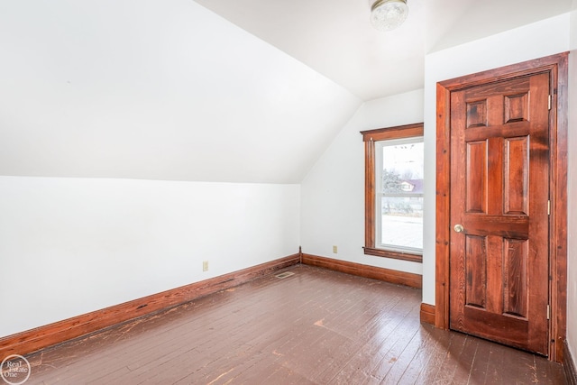 additional living space featuring dark hardwood / wood-style floors and vaulted ceiling