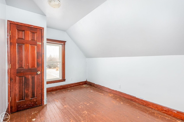 bonus room with hardwood / wood-style flooring and lofted ceiling