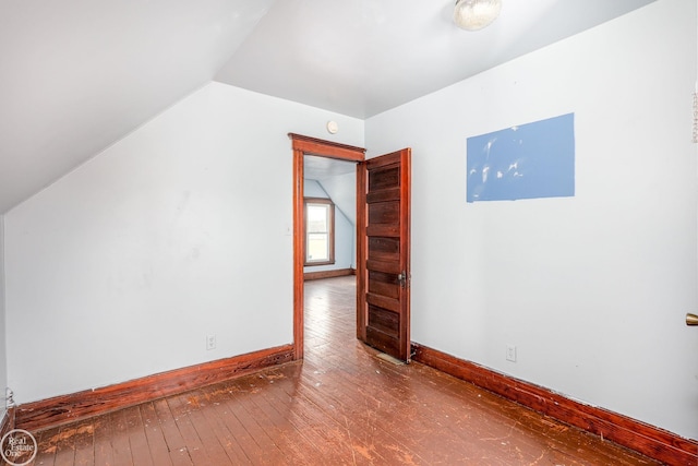 additional living space featuring hardwood / wood-style floors and vaulted ceiling