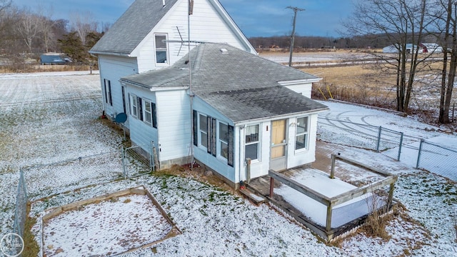 view of snow covered rear of property