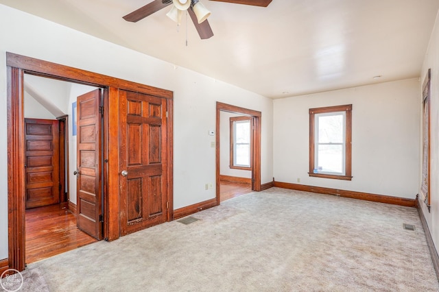 unfurnished bedroom featuring ceiling fan and light carpet