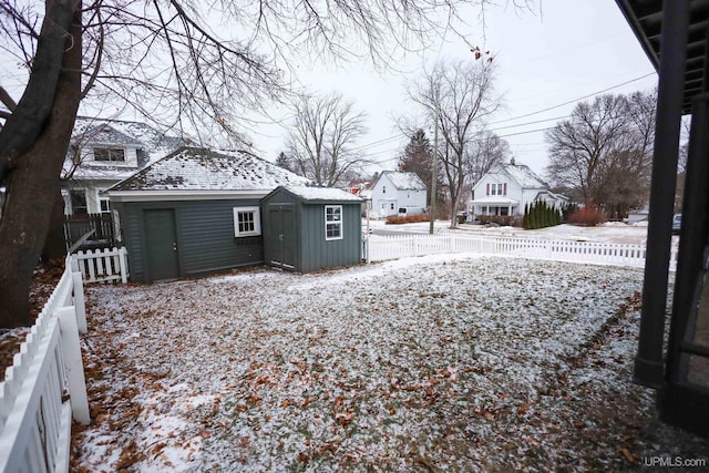 yard covered in snow featuring an outdoor structure