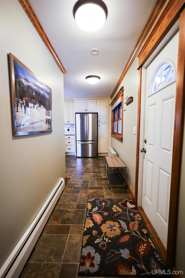 hallway with ornamental molding and baseboard heating