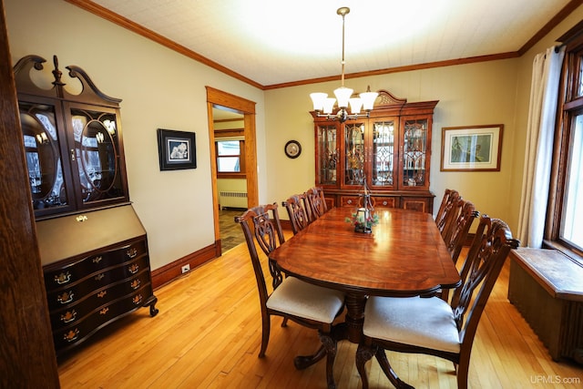 dining area with ornamental molding, radiator heating unit, a chandelier, and light hardwood / wood-style flooring