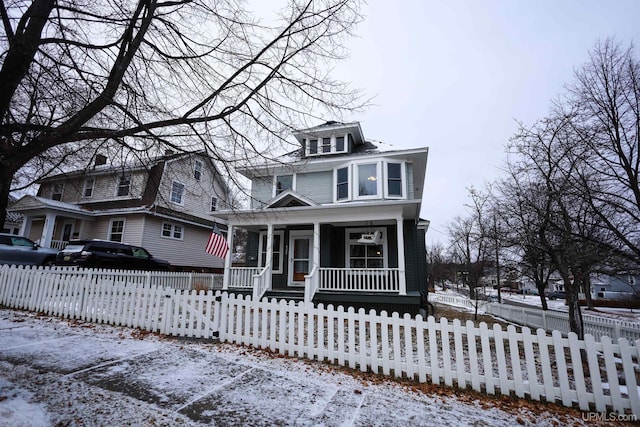 view of front of property featuring cooling unit and a porch