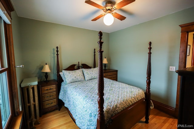 bedroom with light hardwood / wood-style floors and ceiling fan