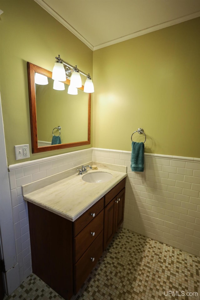 bathroom with tile patterned flooring, vanity, tile walls, and ornamental molding