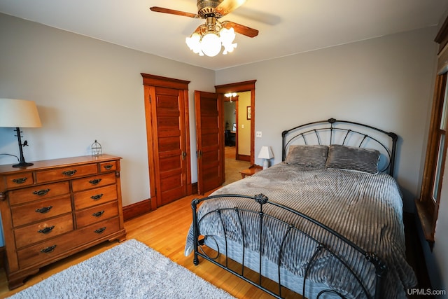 bedroom with light hardwood / wood-style flooring and ceiling fan