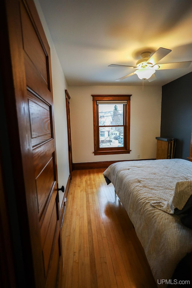 bedroom featuring ceiling fan and light hardwood / wood-style flooring