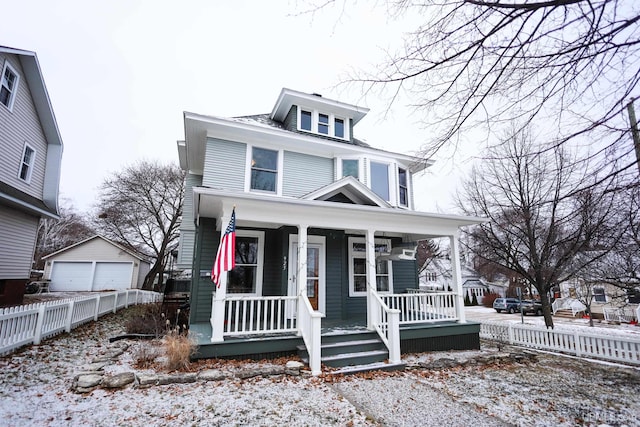 view of front facade featuring an outbuilding, a porch, and a garage