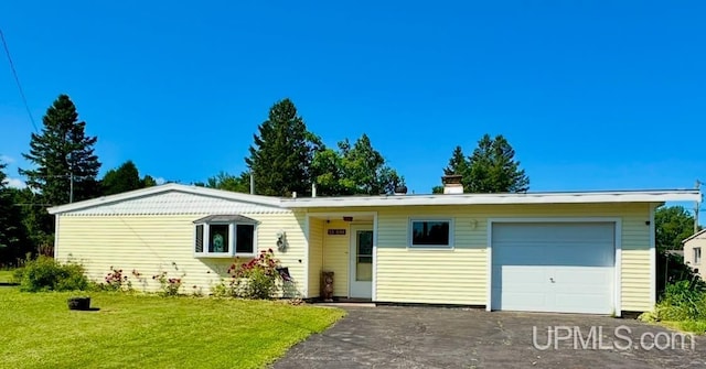 ranch-style house featuring a garage and a front yard