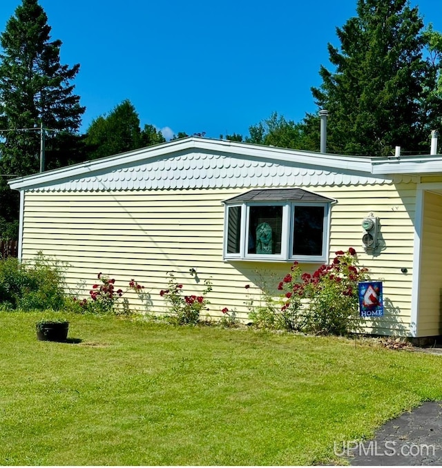 view of home's exterior with a lawn