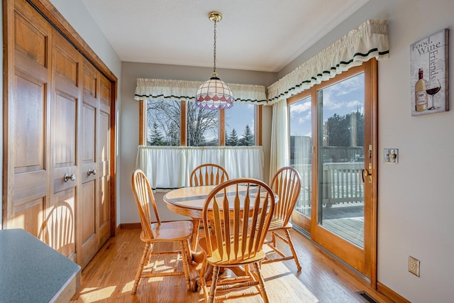 dining area with a chandelier and light hardwood / wood-style floors