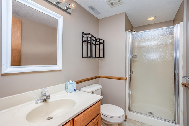 bathroom with toilet, an enclosed shower, a textured ceiling, and vanity