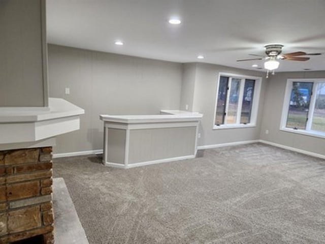 unfurnished living room featuring carpet floors and ceiling fan