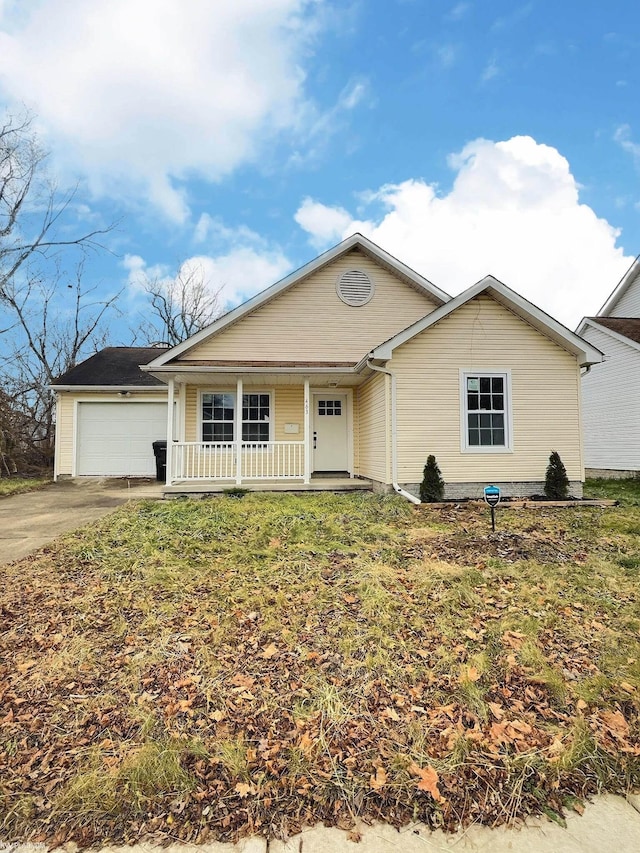 ranch-style home with a front lawn, a porch, and a garage