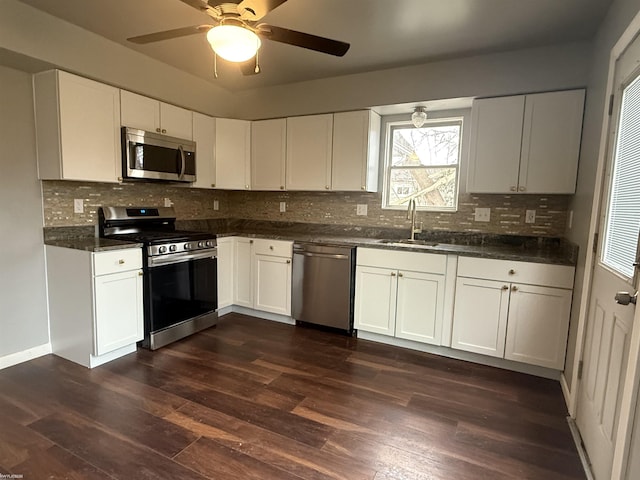 kitchen featuring white cabinets, appliances with stainless steel finishes, dark hardwood / wood-style flooring, and sink