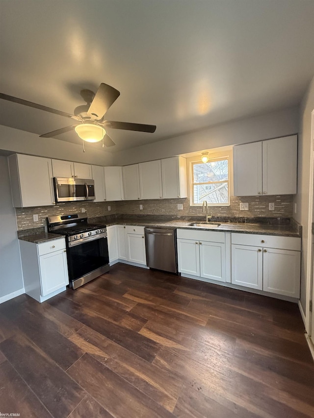 kitchen featuring ceiling fan, sink, dark wood-type flooring, white cabinets, and appliances with stainless steel finishes