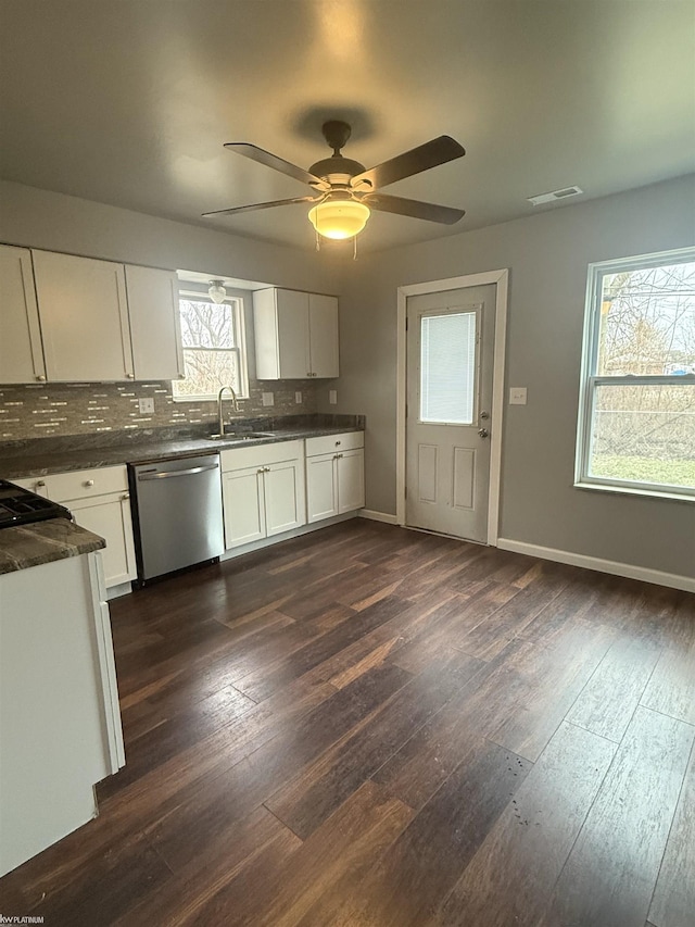 kitchen with a healthy amount of sunlight, white cabinetry, ceiling fan, and stainless steel dishwasher