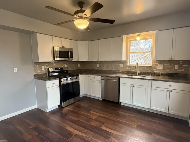 kitchen with ceiling fan, sink, stainless steel appliances, dark hardwood / wood-style flooring, and white cabinets