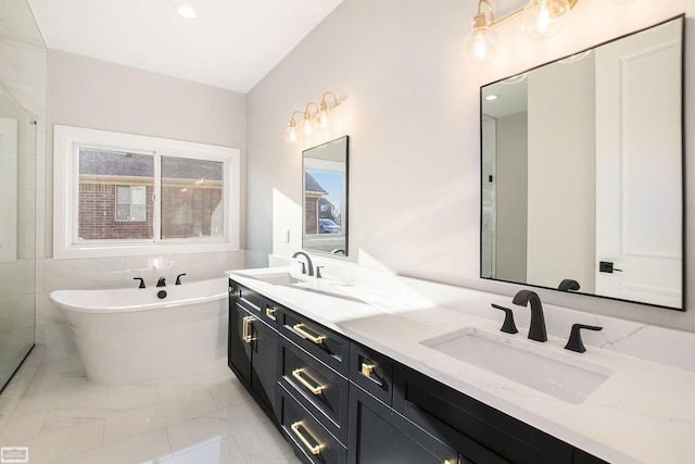 bathroom with tile patterned floors, a washtub, and vanity