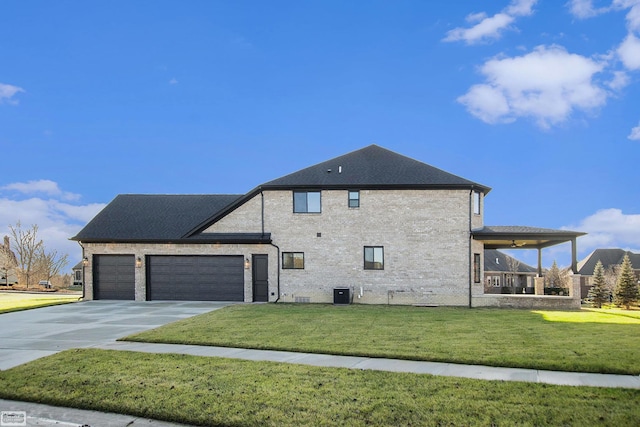 exterior space with a yard, a garage, and central AC unit