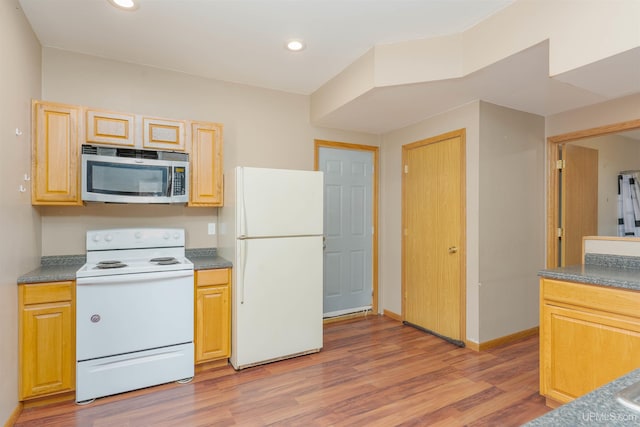 kitchen featuring white appliances and light hardwood / wood-style flooring