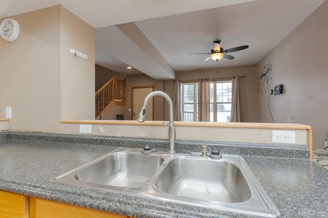 kitchen featuring ceiling fan and sink