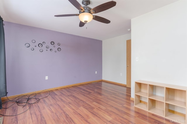 empty room with ceiling fan and hardwood / wood-style floors