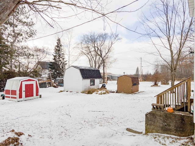 yard covered in snow with a shed