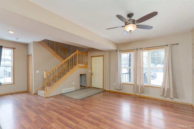 unfurnished living room with hardwood / wood-style flooring and ceiling fan