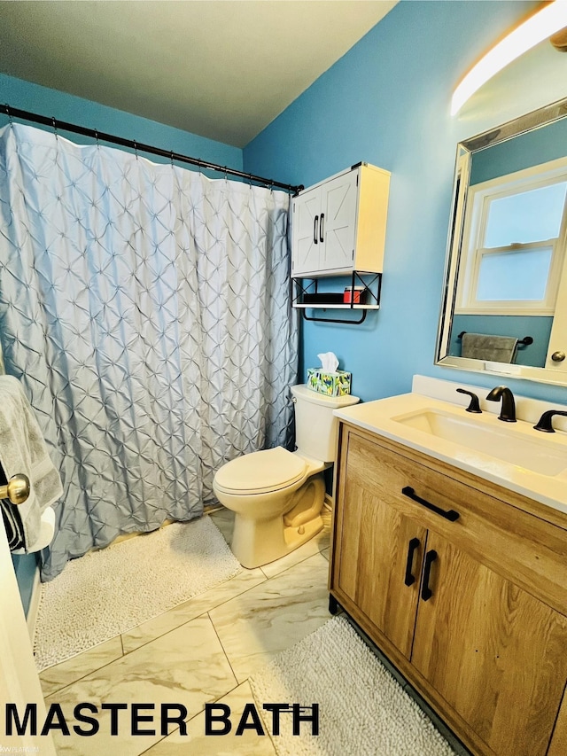 bathroom with vanity and toilet