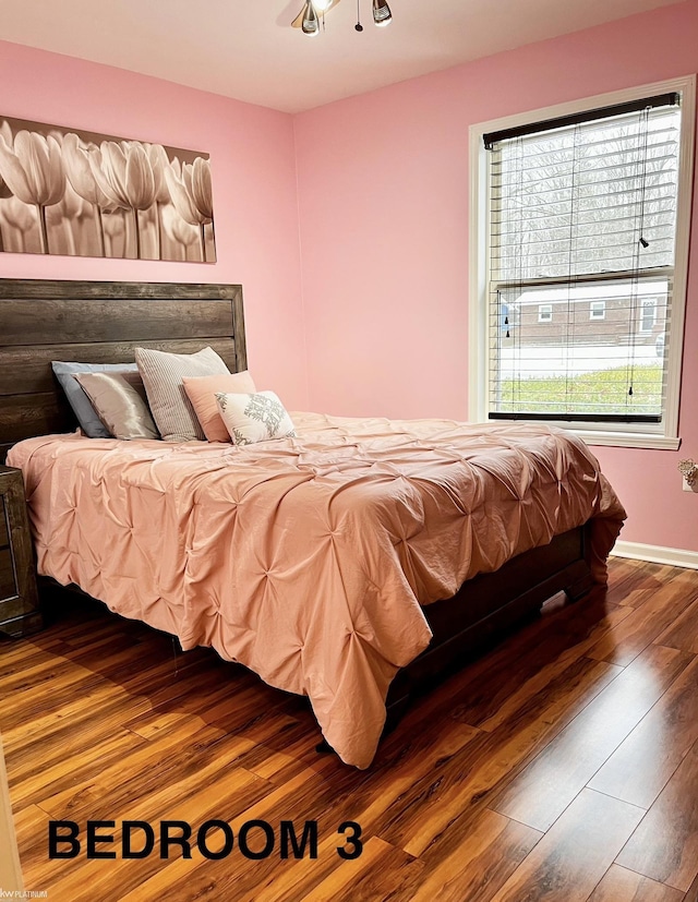 bedroom featuring hardwood / wood-style floors and ceiling fan