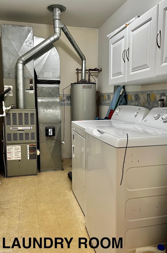 clothes washing area featuring cabinets, gas water heater, heating unit, and washing machine and clothes dryer