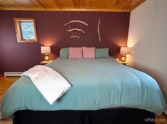 bedroom featuring baseboard heating, wood ceiling, and wood-type flooring