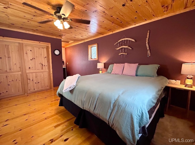 bedroom with ceiling fan, light hardwood / wood-style flooring, wood ceiling, and ornamental molding