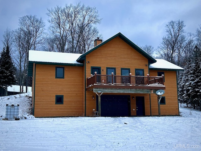 view of front of house featuring a balcony and a garage