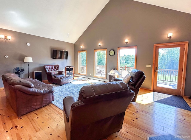 living room featuring light hardwood / wood-style flooring and high vaulted ceiling